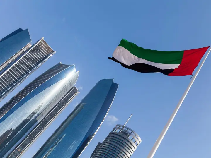 UAE flag above commercial towers